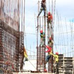 people working on building during daytime